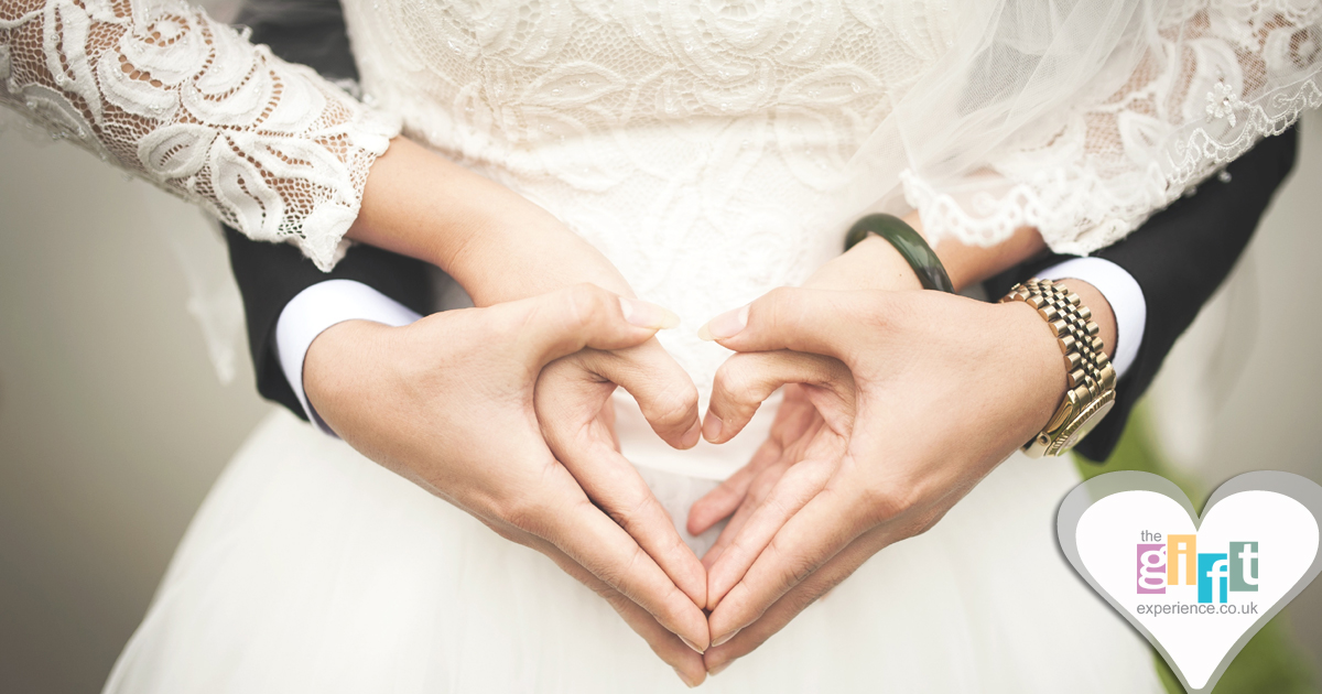 Bride and Groom making a heart with their hands