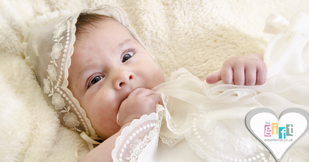 a baby in a christening gown