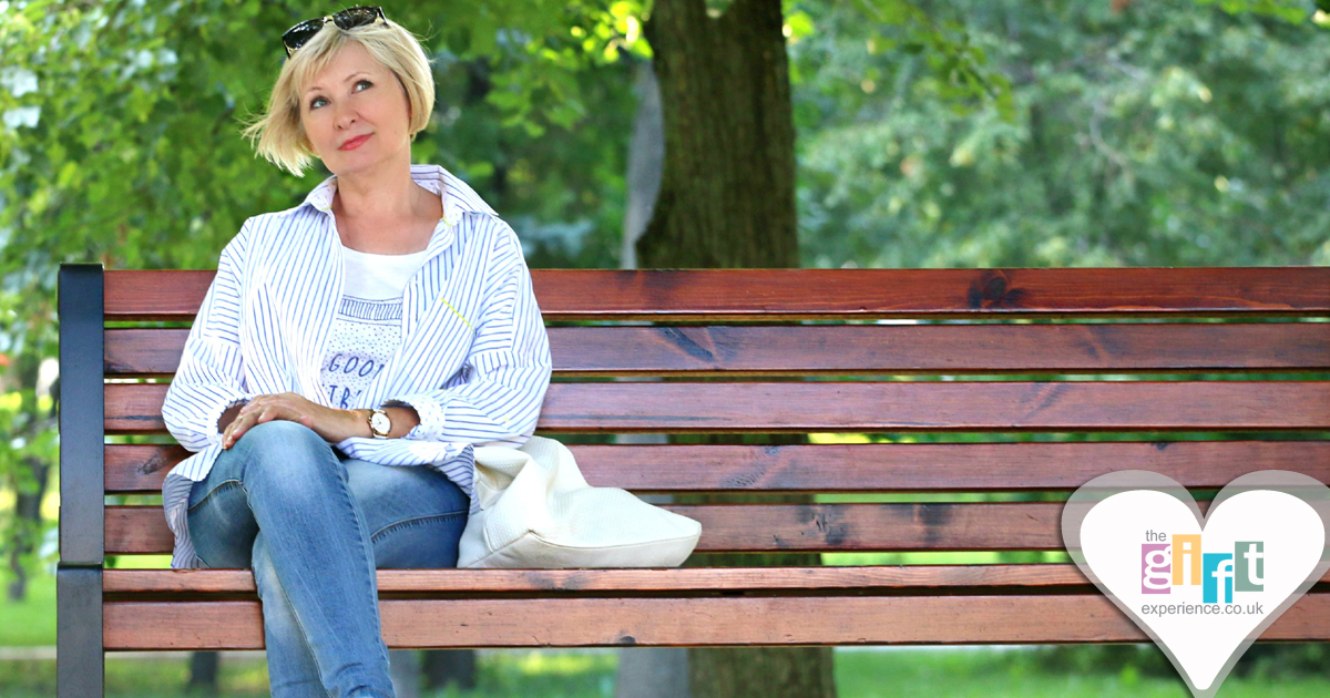 40 year old woman sitting on a bench