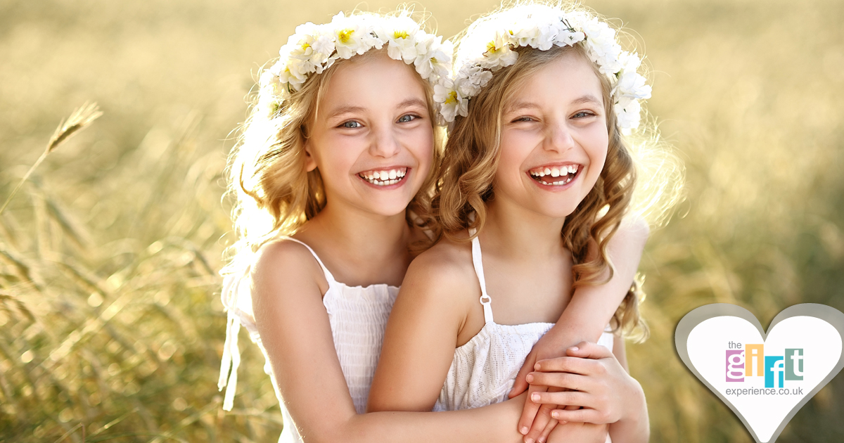 Two pretty flower girls playing and smiling