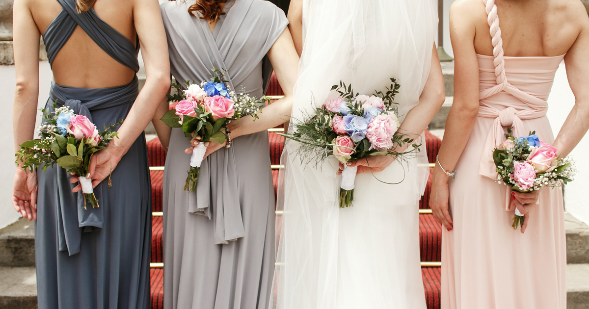 Bride and Bridesmaids holding their bouquets and about to walk down the aisle