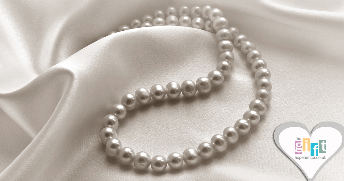 pearl necklace on cream silk