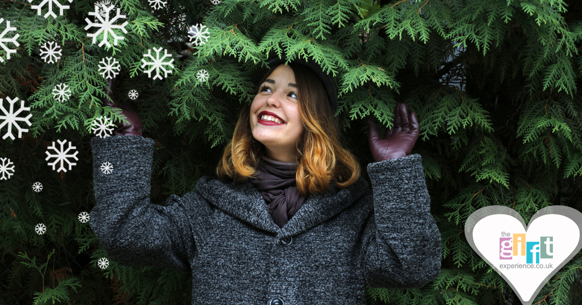 Woman by a Christmas tree with snow